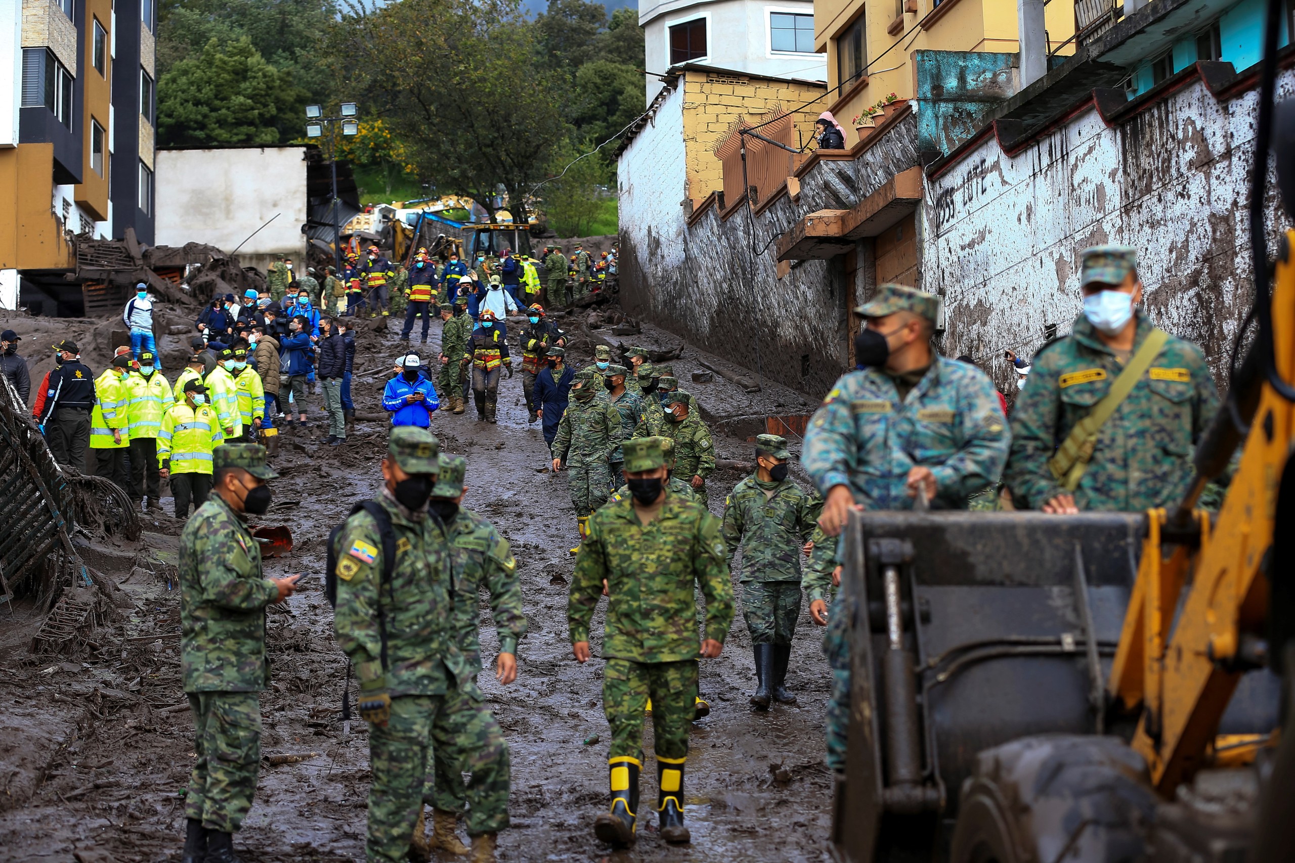 epa09721350 Soldiers help in the cleaning work on the mudslide caused by the rains of 31 January, which affected some neighborhoods in the west of the Ecuadorian capital and caused at least 18 fatalities, as reported by the authorities in Quito, Ecuador, 01 February 2022. The number of people who died on 31 January rose to 18 after a flood that affected several neighborhoods in the west of the Ecuadorian capital, a city that was hit by a heavy downpour, with record rainfall, according to authorities.  EPA/Jose Jacome