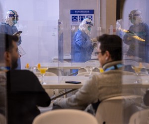 epa09729919 Health workers in PPE suits take random samples for COVID-19 in restaurants surface used by accredited Olympics journalists in the Main Media Centre of the Beijing 2022 Olympic Games, Beijing, China, 05 February 2022.  EPA/JEROME FAVRE