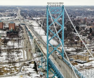 epa09745236 An aerial photo made with a drone looking towards Canada and Canadian Customs shows the closed Ambassador Bridge over the Detroit River that links the US and Canada between Windsor, Ontario, Canada and Detroit, Michigan, USA, 10 February 2022. The bridge, a vital link where 25 percent of goods between the two countries passes on an estimated 10,000 trucks each day, has been shut down by truckers protesting vaccine mandates in Canada.  EPA/TANNEN MAURY