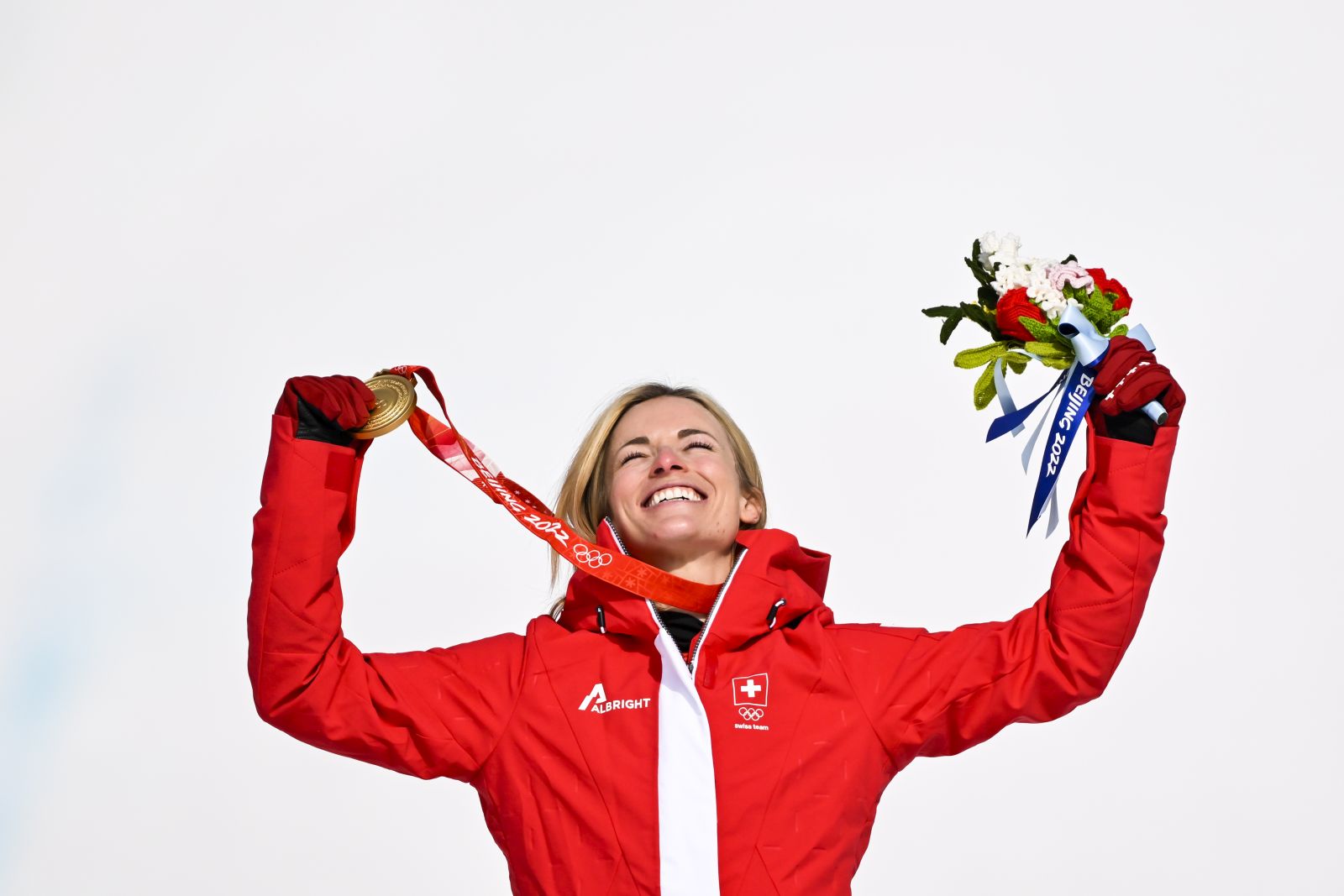 epa09745754 Gold medalist Lara Gut-Behrami of Switzerland celebrates during the victory ceremony of the Women's Super-G race of the Alpine Skiing events of the Beijing 2022 Olympic Games at the Yanqing National Alpine Ski Centre Skiing, Beijing municipality, China, 11 February 2022.  EPA/JEAN-CHRISTOPHE BOTT