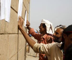 epa09750735 Yemenis look up their names on the lists of emergency food aid beneficiaries amid a severe food insecurity, at al-Jarahi town in the port province of Hodeidah, Yemen, 10 February 2022 (Issued 12 February 2022).  The United Nations has warned that further three million Yemenis might be receiving a reduced food ration at the end of February 2022, joining other eight million the World Food Program (WFP) had significantly cut their food rations by half after UN aid agencies suspended almost two thirds of vital relief programs in war-ridden Yemen as of January 2022 due to severe funding shortfalls. Only two million people out of the total 13 million WFP beneficiaries in Yemen might be receiving full ration of food as of next March as the WFP needs 1.97 billion US dollar to sustain life-saving interventions for vulnerable families on the brink of famine throughout 2022.  EPA/YAHYA ARHAB