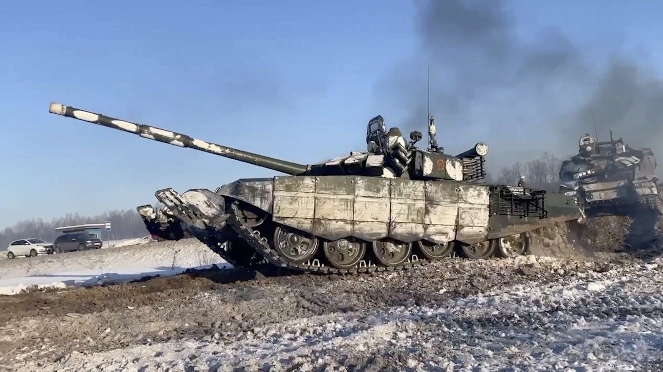 epa09758299 A handout still image taken from handout video made available by the Russian Defence Ministry press service shows Russian tanks return from the ground shooting range on the Voronezh region, Russia, 15 February 2022. Units of the Western and Southern military districts on 15 February begin returning from exercises to their bases by rail and road, the Russian Defense Ministry said.  EPA/RUSSIAN DEFENCE MINISTRY PRESS SERVICE HANDOUT  HANDOUT EDITORIAL USE ONLY/NO SALES