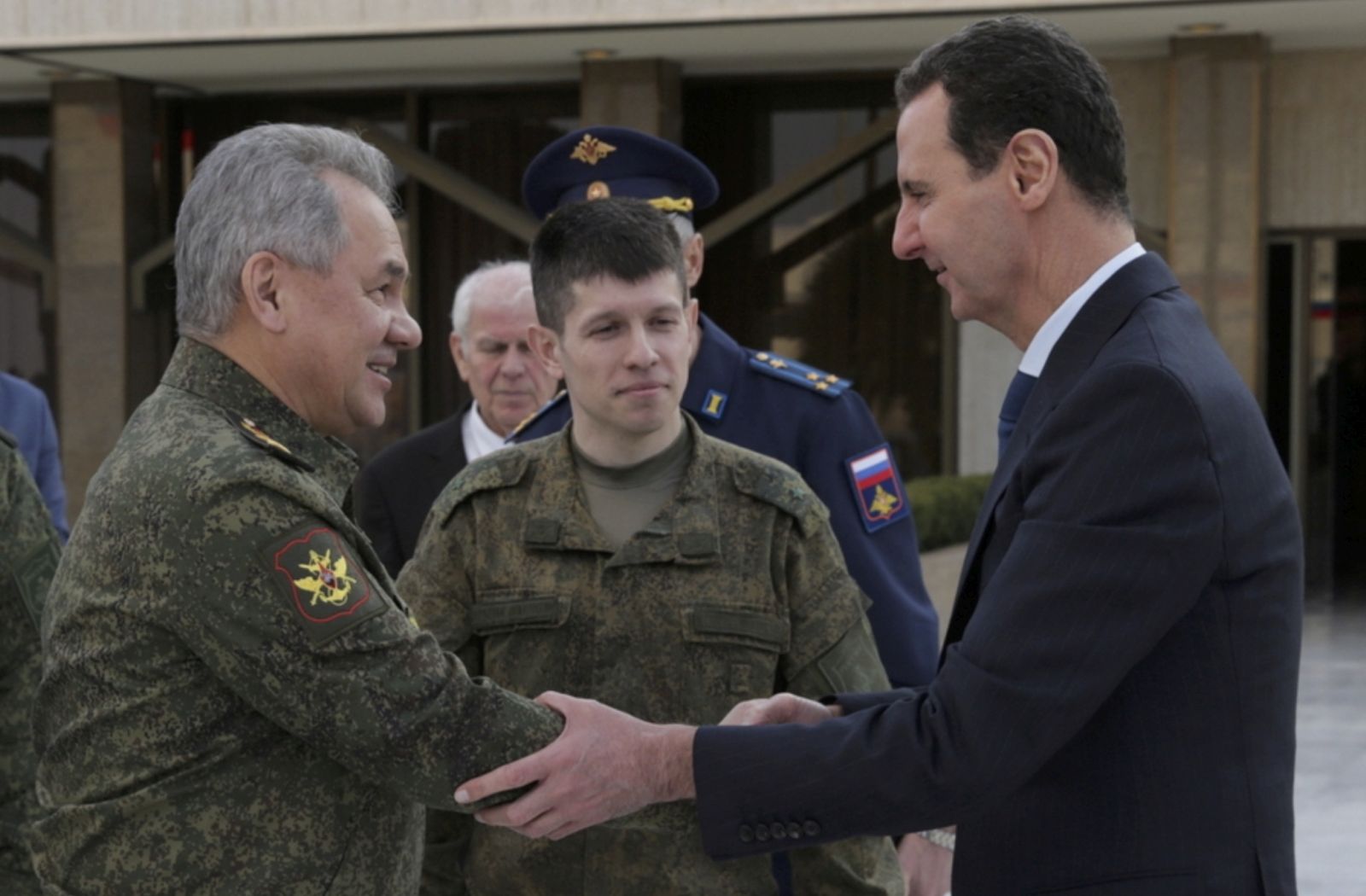 epa09759815 A handout image made available by the Russian Defence Ministry press service shows Russian Defense Minister General of the Army Sergei Shoigu (L) shakes hands with Syrian President Bashar al-Assad (R) during their meeting in Damascus, Syria, 15 February 2022.  EPA/RUSSIAN DEFENCE MINISTRY PRESS SERVICE/HANDOUT MANDATORY CREDIT HANDOUT EDITORIAL USE ONLY/NO SALES