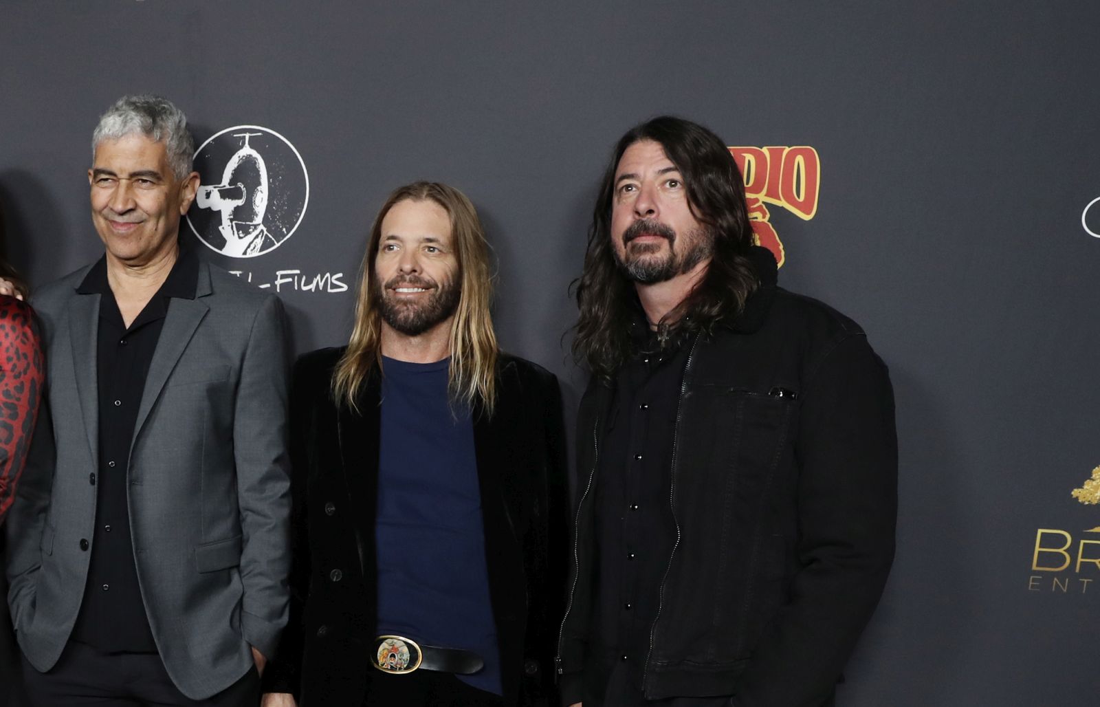 epa09764501 (L-R) US musicians Rami Jaffee, Chris Shiflett, Nate Mendel, US comedian Whitney Cummings, US musicians Pat Smear, Taylor Hawkins, and Dave Grohl, attend the premiere of the movie 'Studio 666' at the TCL Chinese Theater in Los Angeles, California, USA, 16 February 2022.  EPA/CAROLINE BREHMAN
