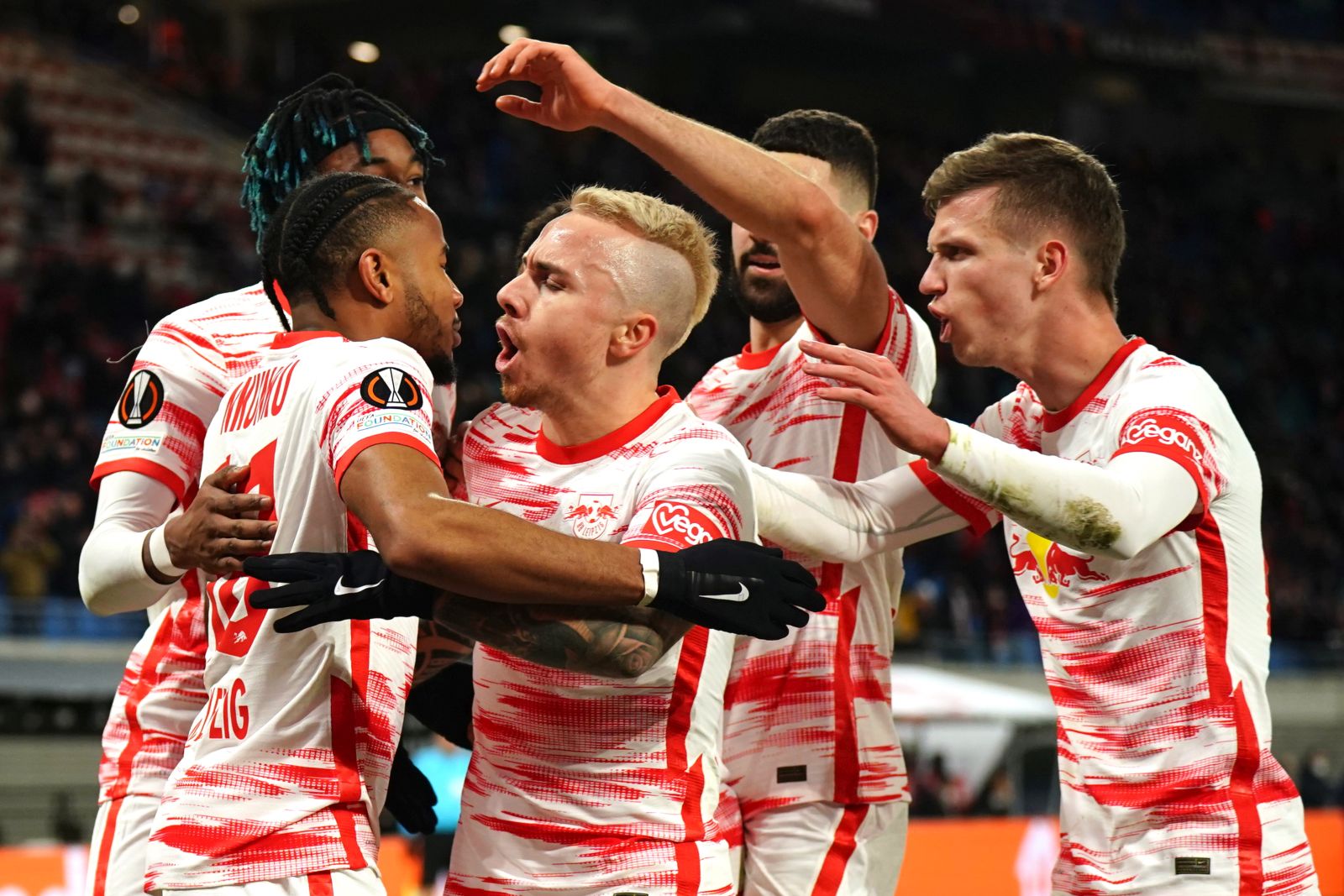 epa09767531 Leipzig’s Christopher Nkunku (2-L) celebrates with teammates after scoring the 1-1 goal during the UEFA Europa League play-off soccer match between RB Leipzig and Real Sociedad in Leipzig, Germany, 17 February 2022.  EPA/CLEMENS BILAN