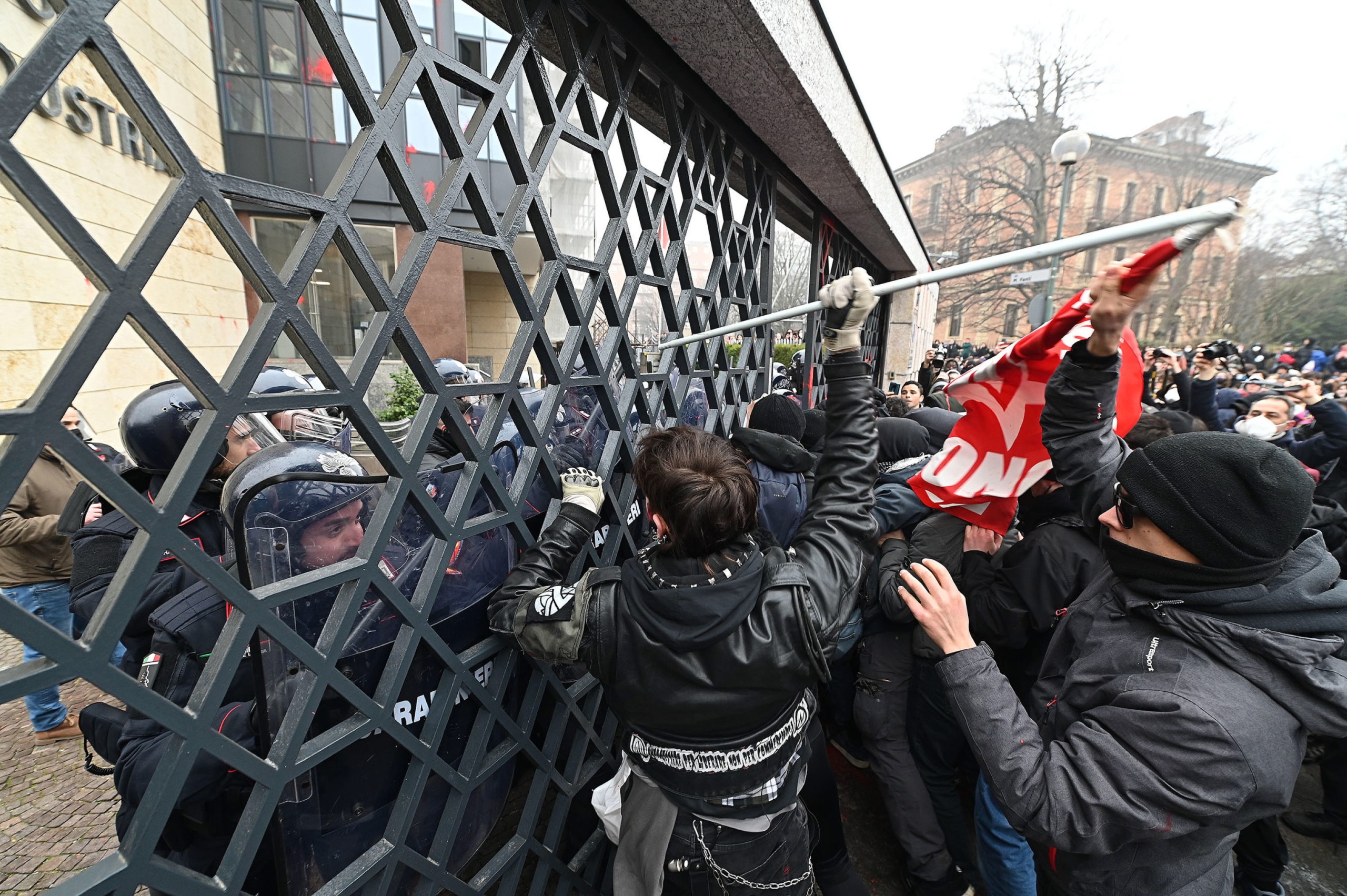 epa09769121 Students try to break into the headquarters of Confindustria (The General Confederation of Italian Industry) during a protest in Turin, Italy, 18 February 2022. Students took to the streets in around 40 Italian cities to protest after two teenagers died in two separate incidents while on training internships. At least seven officers were hurt during clashes with students in Turin.  EPA/Alessandro Di Marco