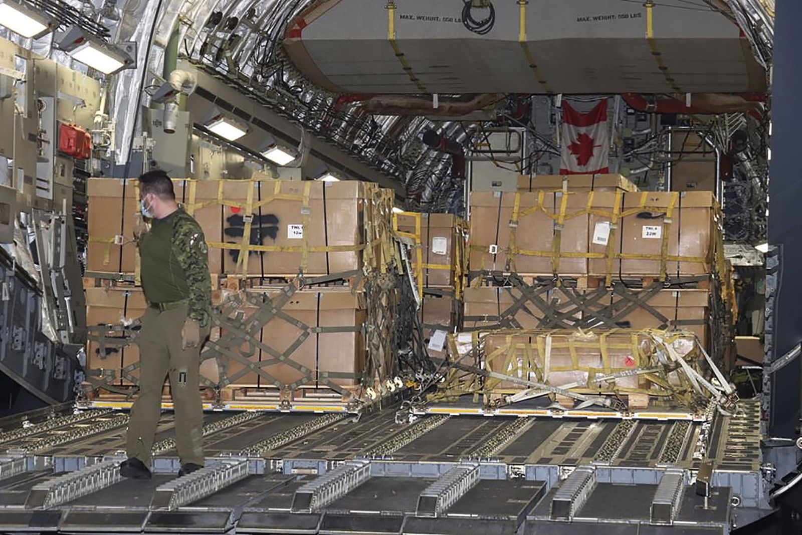 epa09773103 A handout picture made available by Defence Ministry press service shows crew members unload military aid delivered from the Canada to Ukraine from the C-17 cargo plane of the Royal Canadian Air Force , at the airport outside of Western-Ukrainian city of Lviv, Ukraine 19 February 2022. Canada has sent a second weapon shipment to Ukraine amid fears of a Russian invasion. The first plane landed in Ukraine on 04 February 2022.  EPA/Defence Ministry press service handout  HANDOUT EDITORIAL USE ONLY/NO SALES