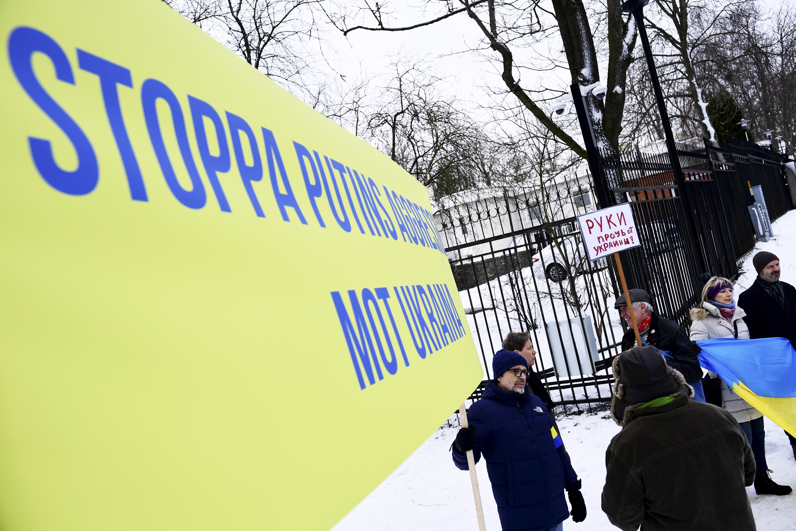 epa09778507 A man holds a banner reading 'Stop Putin's aggressions against Ukraine' during a protest outside the Russian embassy in Stockholm, Sweden, 23 February 2022.  EPA/Paul Wennerholm/TT  SWEDEN OUT