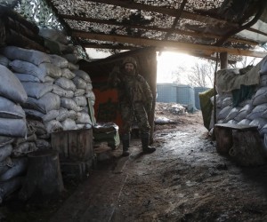 epa09779267 An Ukrainian serviceman reacts while on guard at a position near the Katerynivka village not far from pro-Russian militants controlled city of Luhansk, Ukraine, 23 February 2022. Russia on 21 February 2022 recognized the eastern Ukrainian self-proclaimed breakaway regions as independent states and ordered the deployment of peacekeeping troops to the Donbas, triggering an expected series of economic sanctions announcements by Western countries. The self-proclaimed Donetsk People's Republic (DNR) and Luhansk People's Republic (LNR) declared independence in 2014 amid an armed conflict in eastern Ukraine.  EPA/ZURAB KURTSIKIDZE