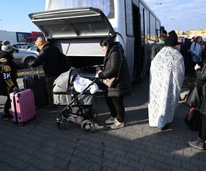 epa09786033 People arrive at a place of help for war refugees from Ukraine organized in a car park next to one of the shops in Przemysl, Poland, 26 February 2022. Poles offer their help to refugees, offer pickups from the border and free transport.  EPA/DAREK DELMANOWICZ POLAND OUT