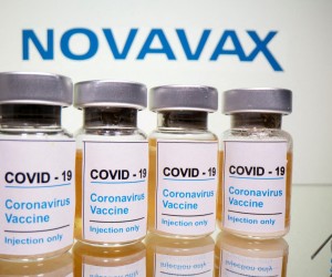 FILE PHOTO: FILE PHOTO: Vials with a sticker reading, "COVID-19 / Coronavirus vaccine / Injection only" and a medical syringe are seen in front of a displayed Novavax logo in this illustration taken October 31, 2020. REUTERS/Dado Ruvic/Illustration/File Photo/File Photo Photo: DADO RUVIC/REUTERS