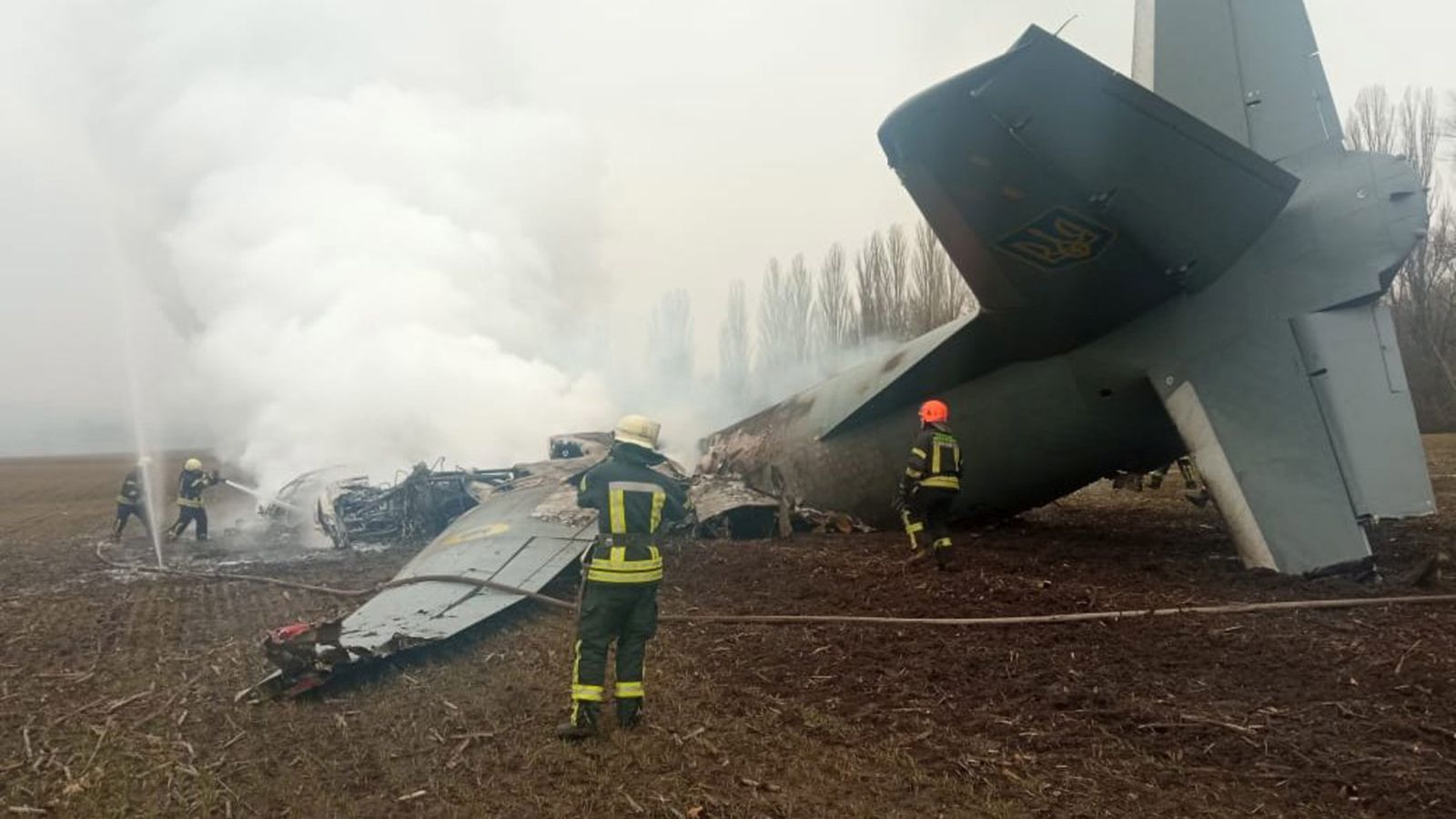 epa09781411 A handout photo released by the press service of the State Emergency Service of Ukraine on 24 February 2022 shows emergency services working at the crash site of a military plane of the Armed Forces of Ukraine, in the Obukhiv district, near Kiev, Ukraine (issued 24 February 2022). According to Ukraine's State Emergency Service the aircraft, with 14 people on board, crashed, with a subsequent fire, in the Kyiv region. Five people died in the incident, the Ministry of Internal Affairs of Ukraine said in a statement.  EPA/STATE EMERGENCY SERVICE OF UKRAINE HANDOUT -- BEST QUALITY AVAILABLE -- MANDATORY CREDIT: STATE EMERGENCY SERVICE OF UKRAINE -- HANDOUT EDITORIAL USE ONLY/NO SALES