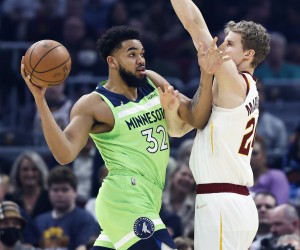 Minnesota Timberwolves' Karl-Anthony Towns (32) looks to pass the ball as Cleveland Cavaliers' Lauri Markkanen (24) defends during the first half of an NBA basketball game Monday, Feb. 28, 2022, in Cleveland. (AP Photo/Ron Schwane)