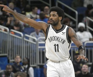 Brooklyn Nets guard Kyrie Irving (11) acknowledges a teammate after scoring a 3-pointer during the first half of an NBA basketball game against the Orlando Magic, Tuesday, March 15, 2022, in Orlando, Fla. (AP Photo/Phelan M. Ebenhack)