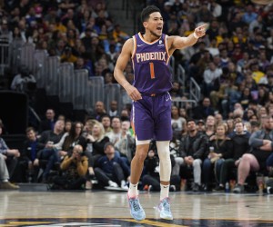 Phoenix Suns guard Devin Booker celebrates late in the second half of the team's NBA basketball game against the Denver Nuggets Thursday, March 24, 2022, in Denver. (AP Photo/David Zalubowski)