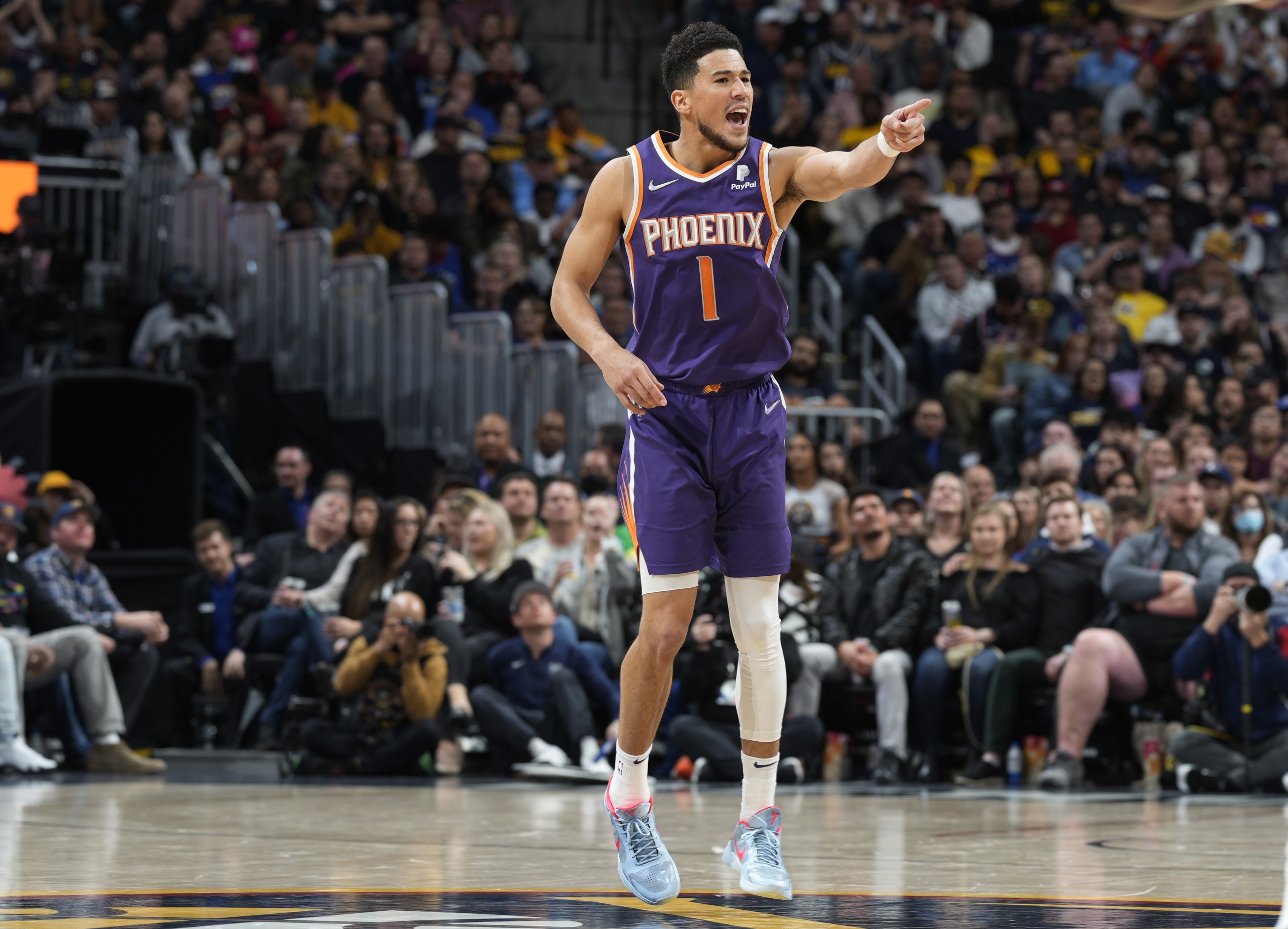 Phoenix Suns guard Devin Booker celebrates late in the second half of the team's NBA basketball game against the Denver Nuggets Thursday, March 24, 2022, in Denver. (AP Photo/David Zalubowski)