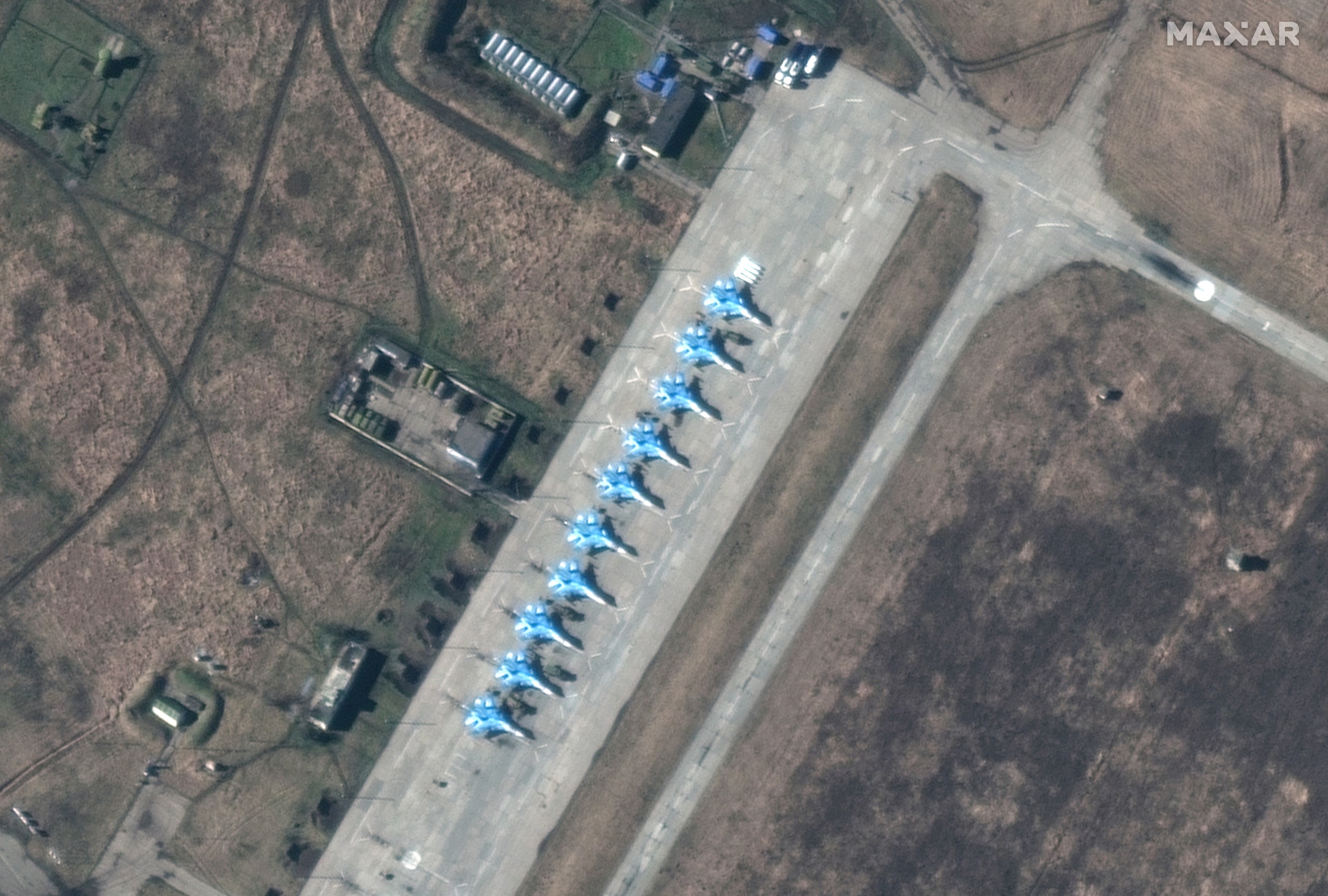 epa09757167 A handout satellite image made available by Maxar Technologies shows a closer view of Sukhoi Su-34 fighters deployment in Primorsko-Akhtarsk airbase, in Krasnodar Krai, Russia, 13 February 2022 (Issued 14 February 2022).  EPA/MAXAR TECHNOLOGIES HANDOUT -- MANDATORY CREDIT: SATELLITE IMAGE 2022 MAXAR TECHNOLOGIES -- THE WATERMARK MAY NOT BE REMOVED/CROPPED -- HANDOUT EDITORIAL USE ONLY/NO SALES