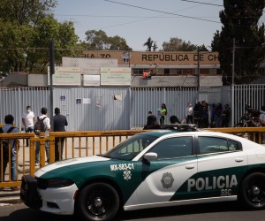 epa09776148 A police car during the exit of students, at the 'Republica de Chile' Secondary School, in Mexico City, Mexico, 21 February 2022. A 12-year-old student was injured on the same day after entering a high school in Mexico City with a pistol and injuring himself with the weapon, according to capital authorities.  EPA/Isaac Esquivel
