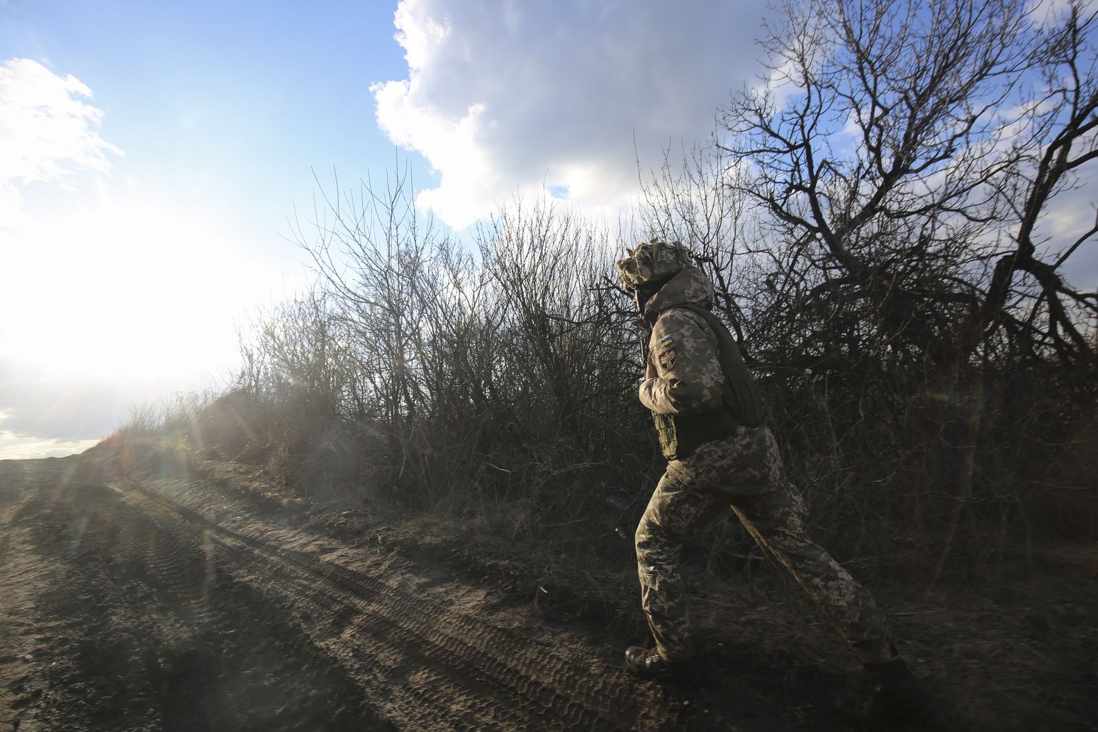 epa09777436 An Ukranian serviceman checks situation on the position near the Zaytseve village not far from pro-Russian militants controlled city of Gorlivka Donetsk area, Ukraine, 21 February 2022 (made available 22 February). Russia on 21 February 2022 recognized the eastern Ukrainian self-proclaimed breakaway regions as independent states and ordered the deployment of peacekeeping troops to the Donbas, triggering an expected series of economic sanctions announcements by Western countries. The self-proclaimed Donetsk People's Republic (DNR) and Luhansk People's Republic (LNR) declared independence in 2014 amid an armed conflict in eastern Ukraine.  EPA/ALISA YAKUBOVYCH