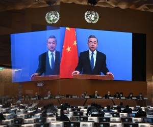 epa09791298 Chinese Foreign minister Wang Yi appears on a screen as he delivers a remote speech at the opening of the 49th session of the UN Human Rights Council in Geneva, Switzerland,  28 February 2022. The UN Human Rights Council voted to hold an urgent debate about Russia's invasion of Ukraine at Kyiv's request, amid widespread international condemnation of Russia's attack.  EPA/FABRICE COFFRINI / POOL
