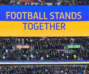 epa09792079 (FILE) - The slogan 'Football stands together' is seen on a huge screen before the English Carabao Cup final between Chelsea FC and Liverpool FC at Wembley in London, Britain, 27 February 2022 (re-issued on 28 February 2022). The world's football governing body FIFA is set to suspend Russia as the International Olympic Committee (IOC) on 28 February 2022 recommended that athletes and officials from Russia and Belarus are banned from all international sports competitions.  EPA/ANDY RAIN EDITORIAL USE ONLY. No use with unauthorized audio, video, data, fixture lists, club/league logos or 'live' services. Online in-match use limited to 120 images, no video emulation. No use in betting, games or single club/league/player publications
