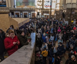 epa09792460 People wait in a hall at Kyiv Main Railway Station as they try to flee from Kyiv (Kiev), Ukraine, 28 February 2022. Thousands of people desperately trying to leave Kyiv, the capital of Ukraine, which has been under Russian military assault. Russian troops entered Ukraine on 24 February prompting the country's president to declare martial law and triggering a series of severe economic sanctions imposed by Western countries on Russia.  EPA/ROMAN PILIPEY