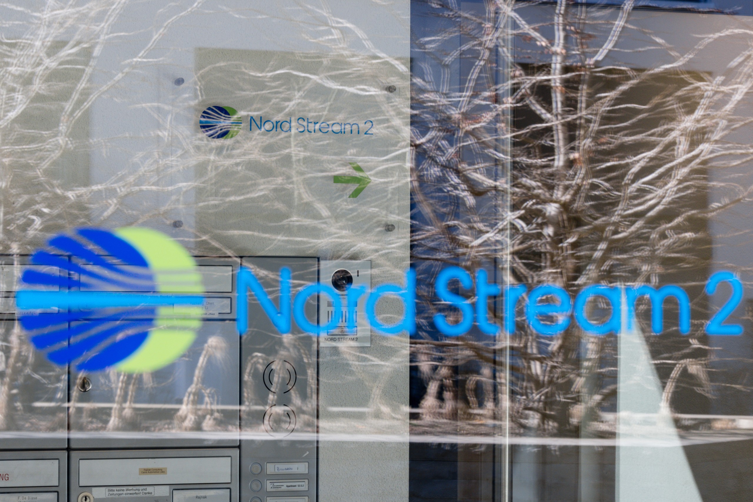 epa09793328 A Nord Stream 2 logo is seen on a reflected glass front of the company's Switzerland headquarters in Zug, Switzerland, 01 March 2022. Zug-based Nord Stream 2, which is implementing the gas pipeline between Russia and Germany, has carried out a mass layoff because of the sanctions taken against Russia. 140 people have lost their jobs, said Swiss Federal Councillor Guy Parmelin.  EPA/PHILIPP SCHMIDLI