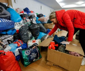 epa09798830 A Ukrainian volunteer sorts humanitarian packages, arranged by the type of product, destined to help the Ukrainian population, at the Embassy of Ukraine in Brussels, Belgium, 03 March 2022. Given the influx of people donating humanitarian packages, Ukraine's embassy in Brussels is no longer able to collect all the donations. A new collection point has been opened at Plais 11 of the Brussels Expo. Only military equipment can still be received at the embassy.  EPA/STEPHANIE LECOCQ