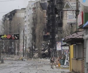 epa09799165 A man goes past burned buildings that were hit by shelling in the small city of Borodyanka near Kiev, Ukraine, 03 March 2022. Russian troops entered Ukraine on 24 February prompting the country's president to declare martial law.  EPA/ALISA YAKUBOVYCH