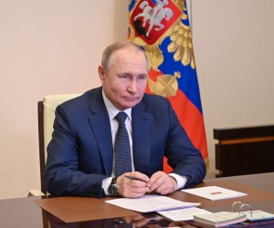 epa09800908 Russian President Vladimir Putin attends a ceremony of raising the national flag on the 'Marshal Rokossovsky' ferry in northern Russia, via a video conference at the Novo-Ogaryovo state residence outside Moscow, Russia, 04 March 2022. The new cargo ferry 'Marshal Rokossovsky', which will serve the crossing between Baltiysk in the Kaliningrad region and Ust-Luga. According to expert estimates, the annual cargo turnover of the new ferry will be approximately 0.7 - 1 million tons. The cargo turnover of the railway ferry complex in Baltiysk in 2021 increased by 9.1 per cent compared to 2020.  EPA/ANDREY GORSHKOV / SPUTNIK / KREMLIN POOL