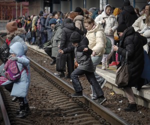 epa09800982 People cross the railway tracks at the main train station as they try to flee Kiev (Kyiv), Ukraine, 04 March 2022. According to the United Nations (UN), at least one million people have fled Ukraine to neighboring countries since the beginning of Russia’s military aggression on 24 February 2022. The UN estimates that around 160,000 Ukrainians are currently internally displaced.  EPA/ZURAB KURTSIKIDZE