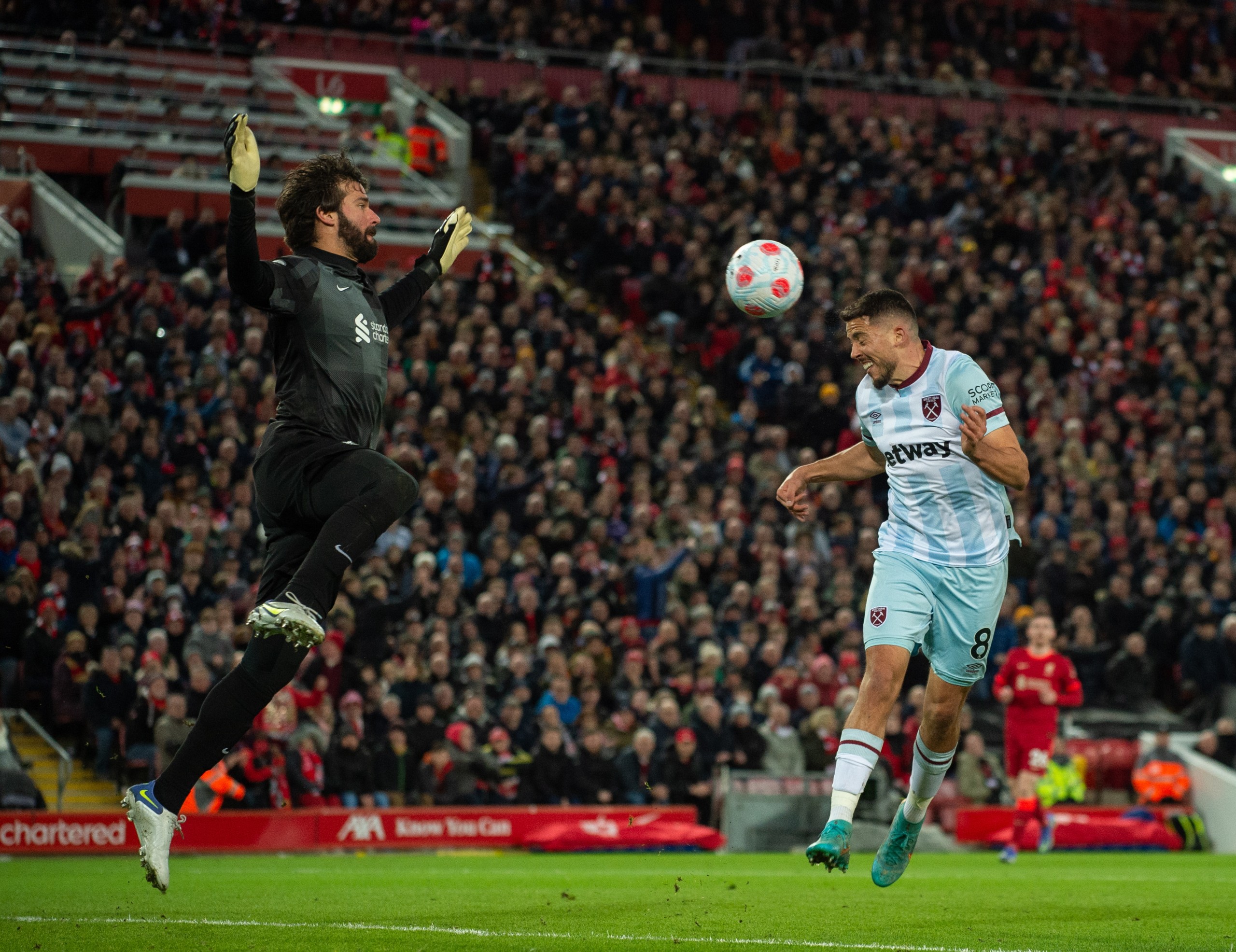 epa09804367 Liverpool's goalkeeper Alisson Becker (L) in action with West Ham United's Pablo Fornals (R) during the English Premier League soccer match between Liverpool FC and West Ham United at Anfield, Liverpool, Britain, 05 March 2022.  EPA/PETER POWELL EDITORIAL USE ONLY. No use with unauthorized audio, video, data, fixture lists, club/league logos or 'live' services. Online in-match use limited to 120 images, no video emulation. No use in betting, games or single club/league/player publications.