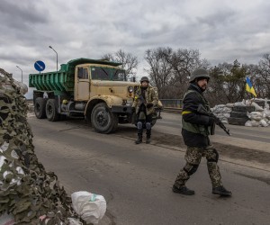 epa09804501 Members of the Territorial Defense Forces stand guard at a checkpoint in the eastern frontline of Kyiv (Kiev) region, Ukraine, 05 March 2022. According to the United Nations (UN), at least one million people have fled Ukraine to neighboring countries since the beginning of Russia's military aggression on 24 February 2022.  EPA/ROMAN PILIPEY