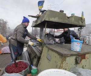 epa09805954 Ukrainians cook food for territorial defense members in their camp near one of blockposts in Kyiv (Kiev), Ukraine, 06 March 2022. Russian troops entered Ukraine on 24 February leading to a massive exodus of Ukrainians to neighboring countries as well as internal displacements.  EPA/SERGEY DOLZHENKO