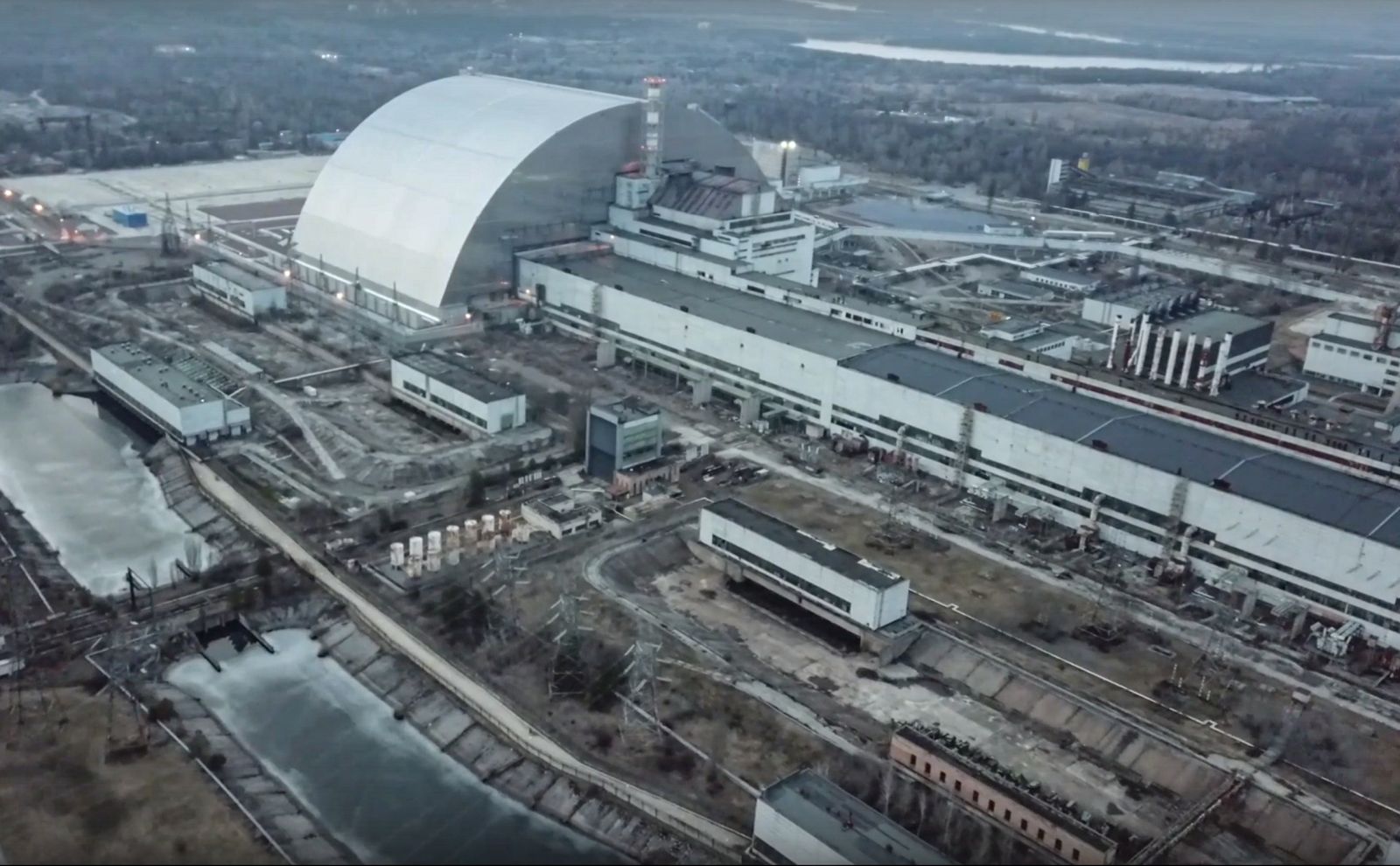 epa09807292 A still image taken from a handout video made available by the Russian Defence Ministry press service shows  a general view of the Chernobyl Nuclear Power Plant in Pripyat, Ukraine, 07 March 2022. Russian President Putin on 24 February 2022 announced a "special military operation against Ukraine". Martial law has been introduced in Ukraine, and explosions are heard in many cities including Kyiv.  EPA/RUSSIAN DEFENCE MINISTRY PRESS SERVICE/HANDOUT HANDOUT  HANDOUT EDITORIAL USE ONLY/NO SALES