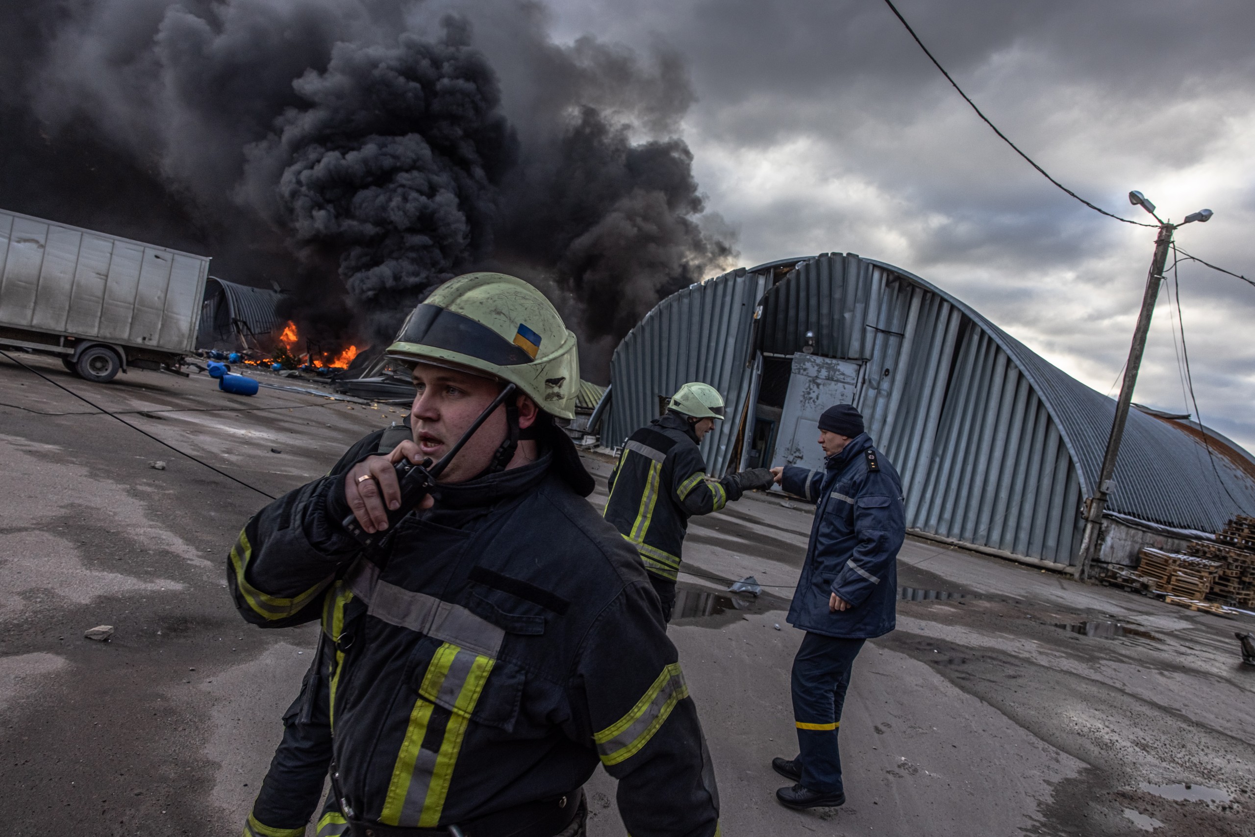 epa09810337 Firefighters in action trying to extinguish the fire at the storage with chemicals which was shelled, on the outskirts of Brovary, the eastern frontline of Kyiv (Kiev) region, Ukraine, 08 March 2022. According to the United Nations High Commissioner for Refugees (UNHCR), Russia's military invasion of Ukraine, which started on 24 February, has destroyed civilian infrastructure and caused civilian casualties, leaving tens of thousands internally displaced and over two million refugees fleeing the country.  EPA/ROMAN PILIPEY