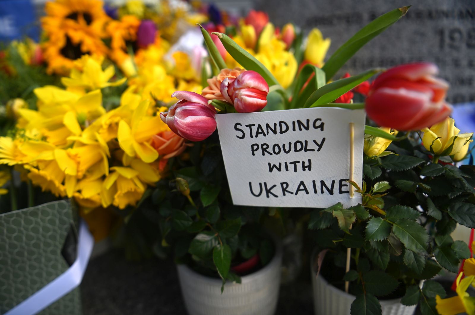 epa09814809 Tributes to Ukraine decorate a monument to St. Volodymyr the Great, near Ukraine's Embassy in London, Britain, 10 March 2022. According to United Nations High Commissioner for Refugees (UNHCR) figures, more than two million Ukrainians have fled their country since Russia began its military invasion of Ukraine on 24 February 2022.  EPA/NEIL HALL
