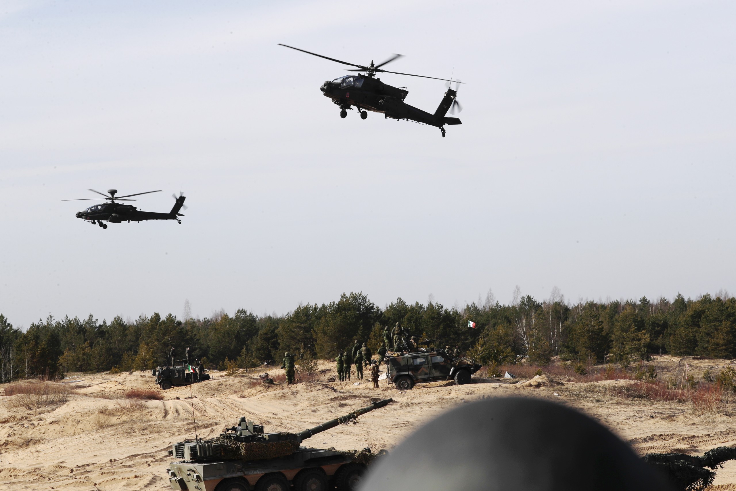 epa09817851 US combat helicopters AH-64 Apache and tanks during the international military exercise Crystal Arrow 22, organized by Mechanized Infantry Brigade of the Latvian Land Forces in Adazi training ground, Latvia, 11 March 2022. The purpose of the force demonstration is to demonstrate the interoperability of multinational units in various operations and to demonstrate NATO's combat capabilities for the protection of any member of the Alliance. With the conclusion of the Crystal Arrow 2022 exercise, the certification process of the NATO Extended Presence Battlegroup in Latvia is being successfully completed.  EPA/TOMS KALNINS