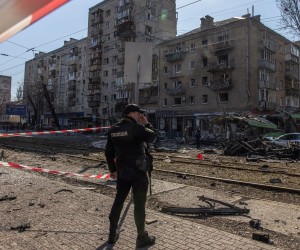 epa09824524 A Ukrainian police officer stands guard at the residential area where the debris of a Russian missile fell after it was shot down, in Kyiv, Ukraine, 14 March 2022. At least one person was killed, Kyiv mayor Klitschko said. Russian troops entered Ukraine on 24 February prompting the country's president to declare martial law and triggering a series of announcements by Western countries to impose severe economic sanctions on Russia.  EPA/ROMAN PILIPEY