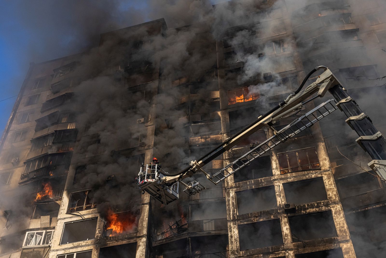 epa09825999 A firefighter extinguishes the fire in a residential building which was hit by artillery shelling, in Kyiv, Ukraine, 15 March 2022. Russian troops entered Ukraine on 24 February prompting the country's president to declare martial law and triggering a series of announcements by Western countries to impose severe economic sanctions on Russia.  EPA/ROMAN PILIPEY