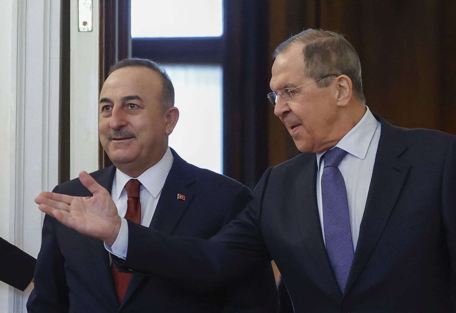 epa09828461 Russian Foreign Minister Sergei Lavrov (R) and Turkish Foreign Minister Mevlut Cavusoglu (L) enter a hall during a meeting in Moscow, Russia, 16 March 2022. Turkish Foreign Minister is on a working visit to Moscow.  EPA/MAXIM SHEMETOV / POOL