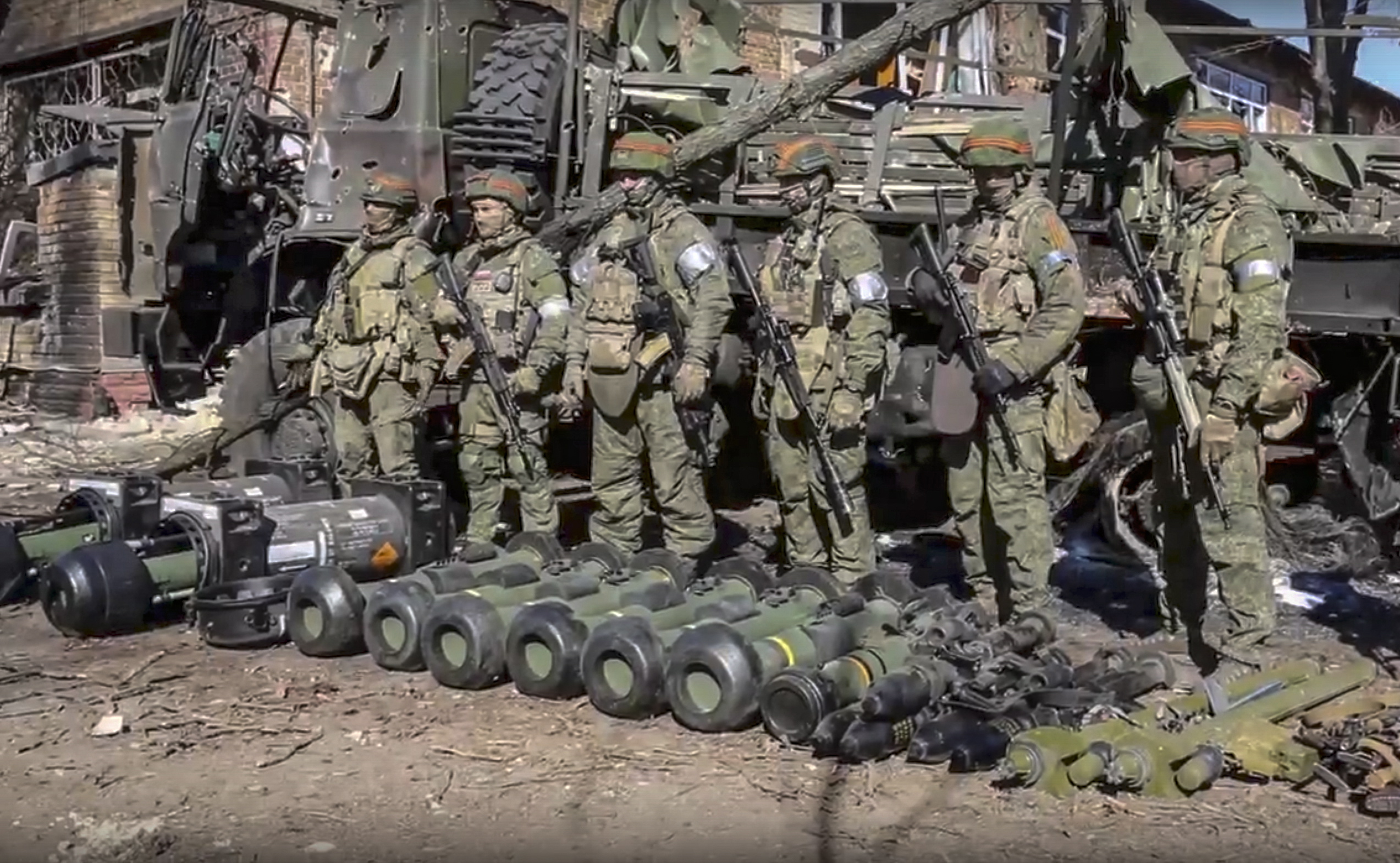 epa09829126 A handout still image taken from handout video made available by the Russian Defence ministry press-service shows Russian servicemen stand next to the US and UK anti-tank missiles that was abandoned by Ukrainian army during their retreat in Donetsk region, Ukraine, 16 March 2022. On 24 February Russian troops had entered Ukrainian territory in what the Russian president declared a 'special military operation', resulting in fighting and destruction in the country, a huge flow of refugees, and multiple sanctions against Russia.  EPA/RUSSIAN DEFENCE MINISTRY PRESS SERVICE / HANDOUT  HANDOUT EDITORIAL USE ONLY/NO SALES