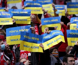 epa09829335 Fans show signs in Ukrainian colours reading 'You'll never walk alone' in support of Ukraine prior to the German Bundesliga soccer match between FSV Mainz 05 and Borussia Dortmund in Mainz, Germany, 16 March 2022.  EPA/FRIEDEMANN VOGEL CONDITIONS - ATTENTION: The DFL regulations prohibit any use of photographs as image sequences and/or quasi-video.