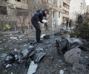 epa09830760 An expert investigates debris of a rocket on the place of shelling of residential building in Kyiv, Ukraine, 17 March 2022. One person was killed and three injured during the shelling. Russian troops entered Ukraine on 24 February prompting the country's president to declare martial law and triggering a series of announcements by Western countries to impose severe economic sanctions on Russia.  EPA/SERGEY DOLZHENKO