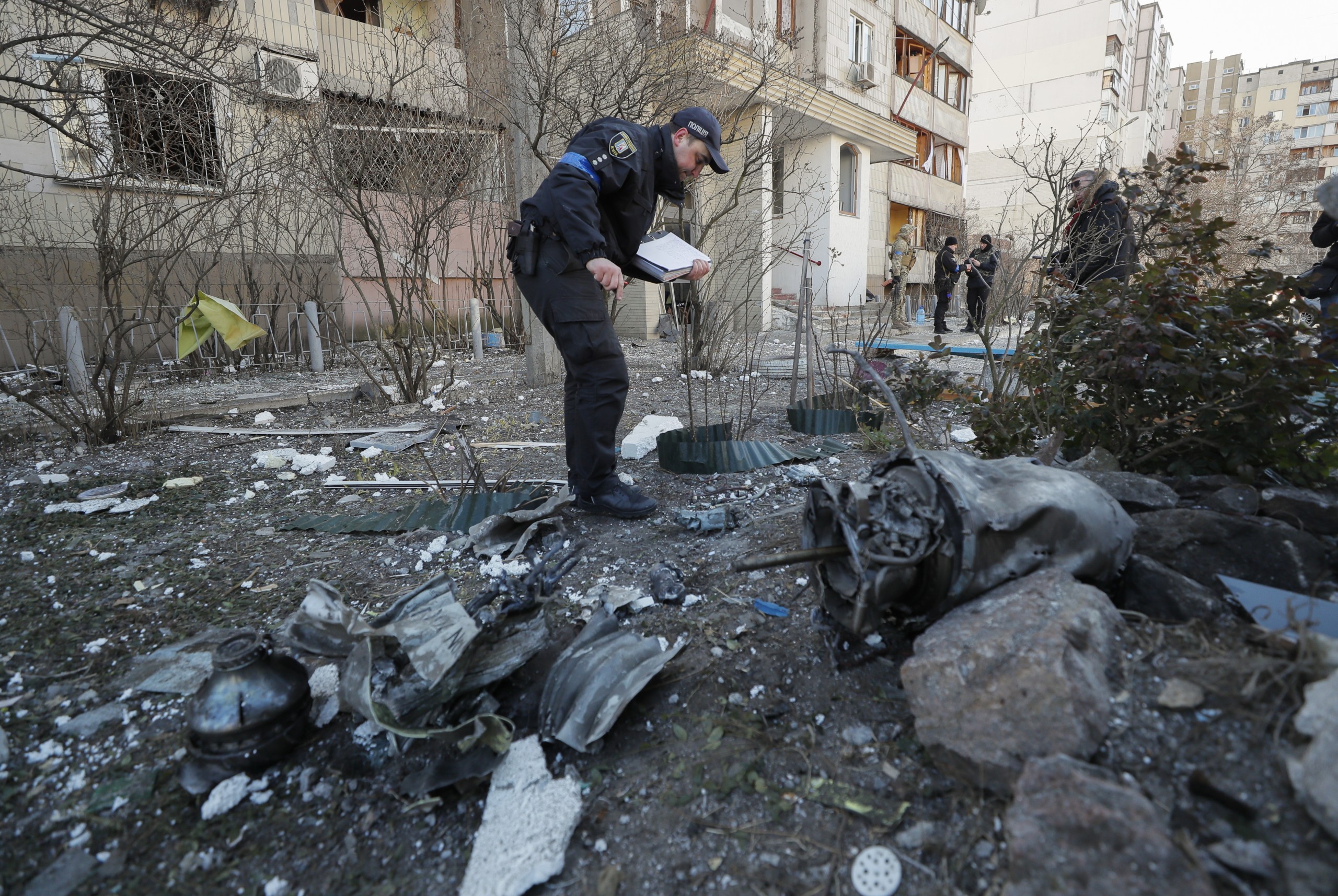epa09830760 An expert investigates debris of a rocket on the place of shelling of residential building in Kyiv, Ukraine, 17 March 2022. One person was killed and three injured during the shelling. Russian troops entered Ukraine on 24 February prompting the country's president to declare martial law and triggering a series of announcements by Western countries to impose severe economic sanctions on Russia.  EPA/SERGEY DOLZHENKO