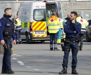 epa09837571 Police officers stand guard at the cordoned off scene in Strepy Bracquegnies, Belgium, 20 March 2022. Six people lost their lives and 26 were injured in the morning, when a car rammed in a carnival crowd.  EPA/JULIEN WARNAND