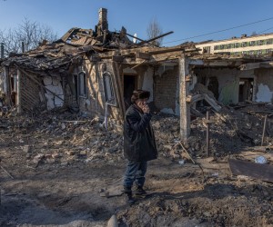 epa09839488 Ihor (67), smokes next to his severely damaged house after the Russian shelling, in Zhytomyr city, north-west Ukraine, 20 March 2022. Russian troops entered Ukraine on 24 February resulting in fighting and destruction in the country, and triggering a series of severe economic sanctions on Russia by Western countries.  EPA/ROMAN PILIPEY