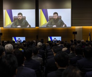 epa09843662 Ukrainian President Volodymyr Zelensky (on screen) addresses Japan's lower house lawmakers during a videoconference at the House of Representatives office building in Tokyo, Japan, 23 March 2022.  EPA/BEHROUZ MEHRI / POOL