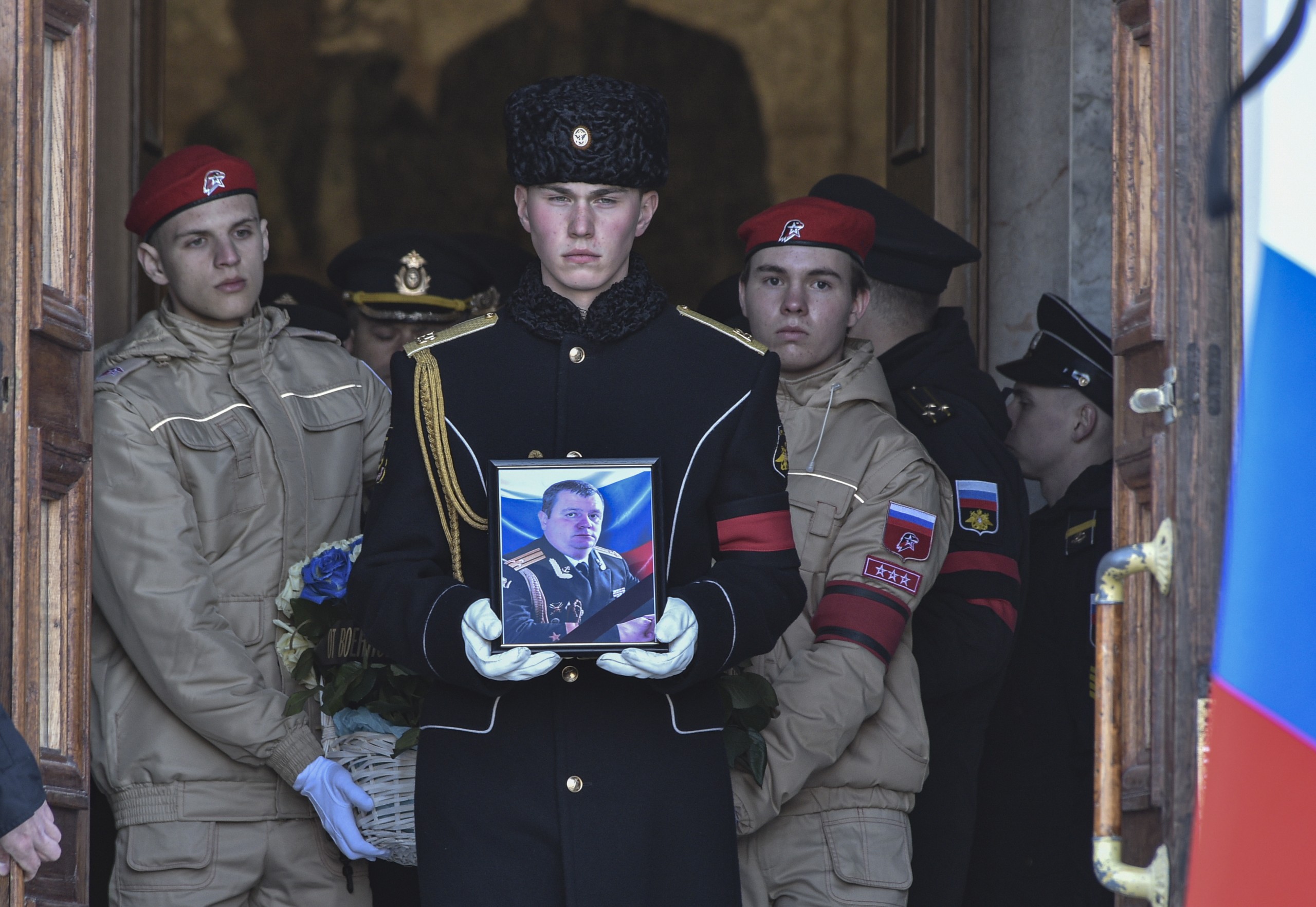 epa09844953 Russian sailors carry a coffin and a photograph of the Deputy Commander of the Black Sea Fleet for Military-Political Work (VPR), Captain 1st Rank Andrei Paly, who was killed in the recent battles of Mariupol, during a farewell ceremony in Sevastopol, Crimea, 23 March 2022. On 24 February Russian troops had entered Ukrainian territory in what the Russian president declared a 'special military operation', resulting in fighting and destruction in the country, a huge flow of refugees, and multiple sanctions against Russia.  EPA/STRINGER