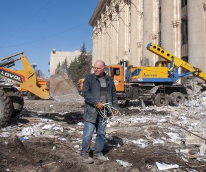 epa09845271 A local man cleans debris from a building damaged after shelling in Kharkiv, Ukraine, 23 March 2022. The city of Kharkiv, Ukraine's second-largest city, has witnessed repeated airstrikes from Russian forces. On 24 February, Russian troops entered Ukrainian territory in what the Russian president declared a 'special military operation', resulting in fighting and destruction in the country, a huge flow of refugees, and multiple sanctions against Russia.  EPA/VASILIY ZHLOBSKY